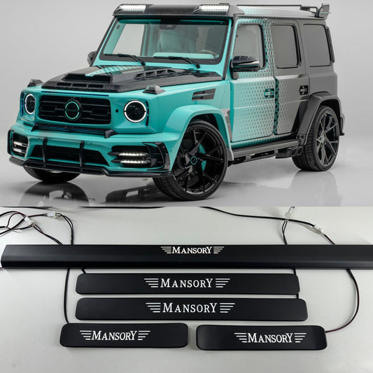 Matte black door sills with 'MANSORY' branding on them, designed for a Mercedes-Benz G-Class, alongside the vehicle they belong to.